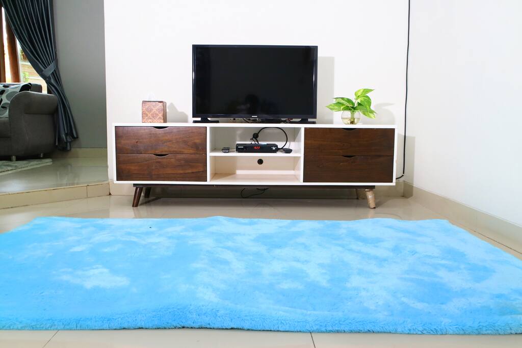 ruang tv bawah untuk bersantai dilengkapi AC dengan karpet dan tivi kabel seluruh channel