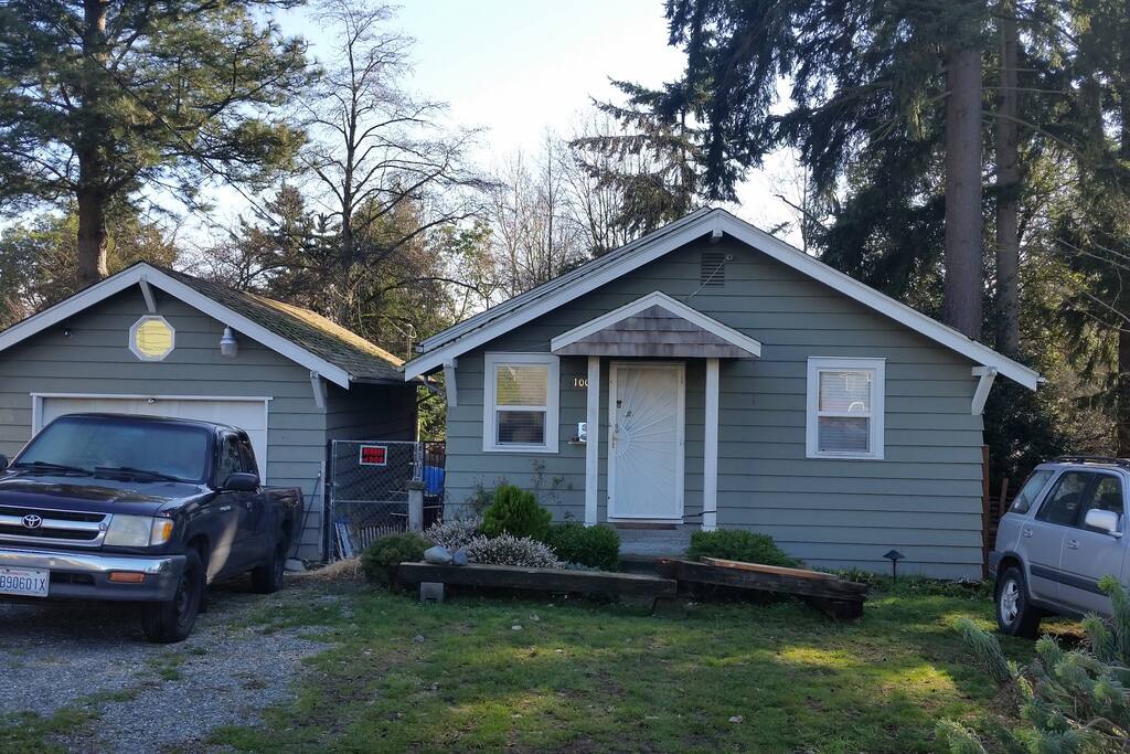 This is the house from the front . Cabins in the back. Go through the gate between the house and garage. Park off the road anywhere in the grass is fine.