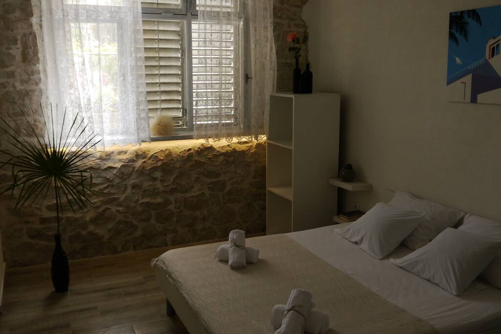 Another look at our clean, sleek and modern room featuring the stone wall.
