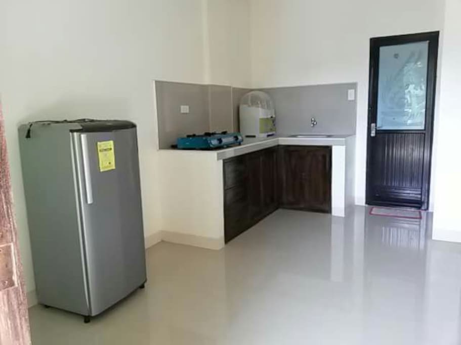 kitchen is with gas stove and refrigerator