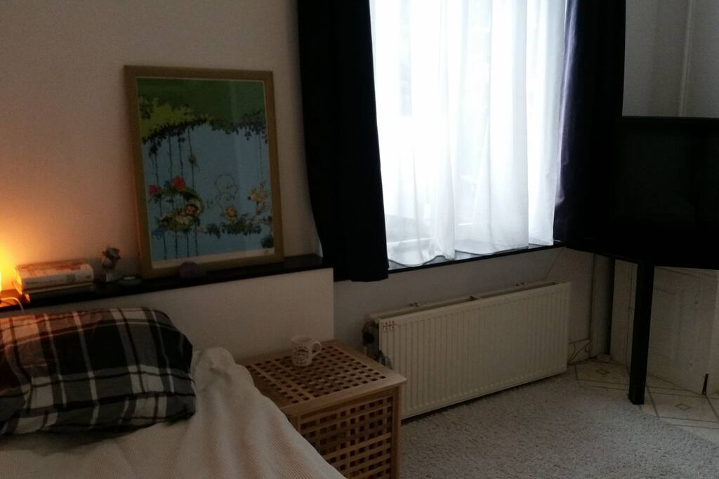 Situated right next to the front door (after a small attic), you enter and leave in complete privacy from the rest of my appartment, the tv is a formerly veeeery expensive B&O :)