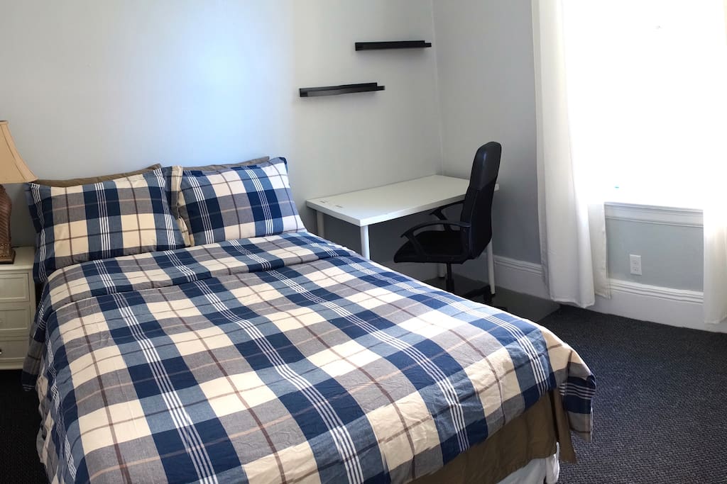 Comfortable queen size bed with shared bathroom.