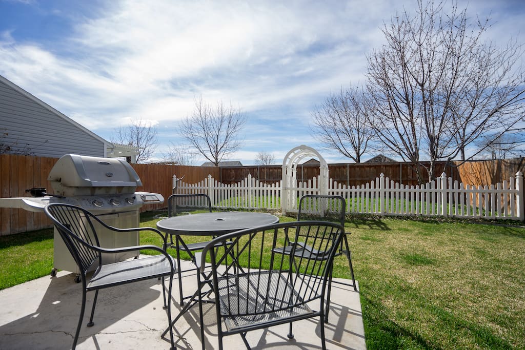 Backyard barbecue with patio furniture. Fully fenced back yard.