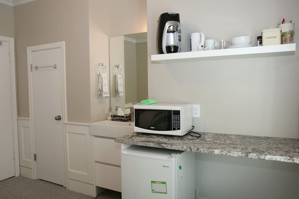 Sink, Kitchenette with microwave, coffee maker, kettle, small fridge