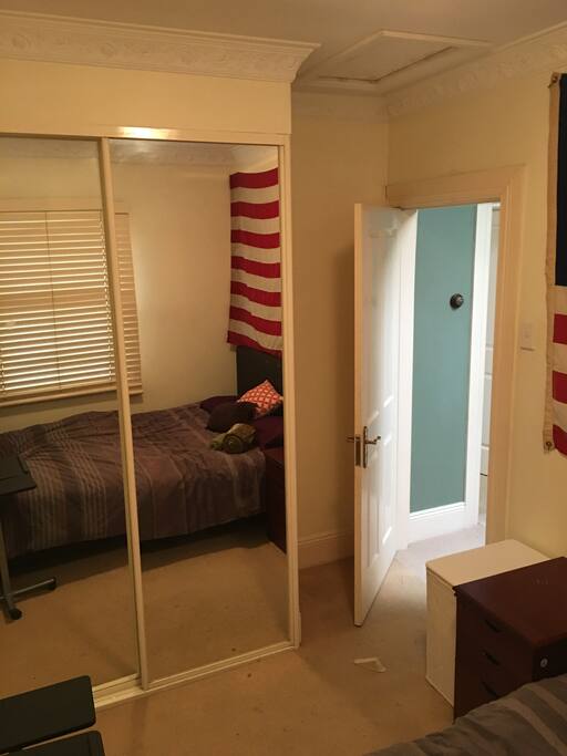Bedroom with double bed on first floor of terrace with shared toilet and shower facilities downstairs.