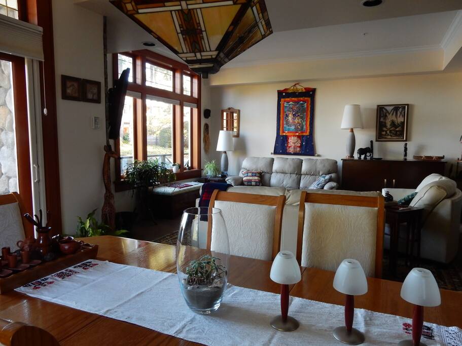 High, large windows facing the water offer a peaceful retreat on stylish, comfortable furniture.