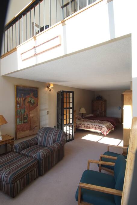 Sitting area and twin beds on lower floor