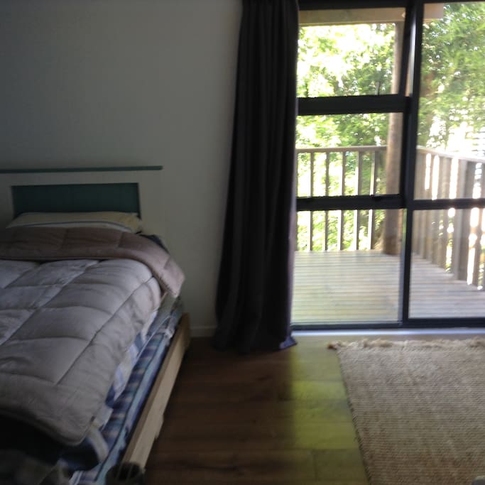 Bedroom 2 with trundler under bead and access to lower deck