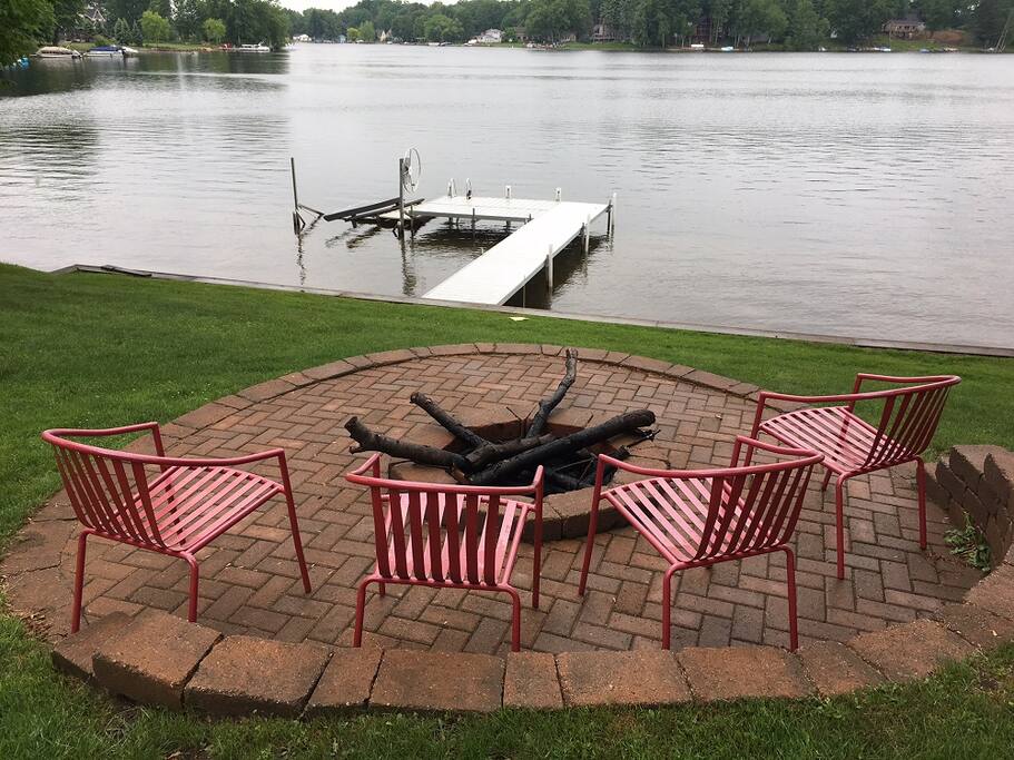 Beautiful stone fire pit by lake