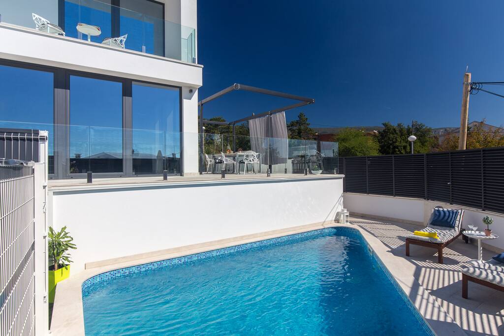 Swimming pool with loungers