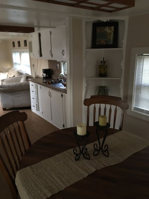 Kitchen with stove, refrigerator, microwave and coffee pot.