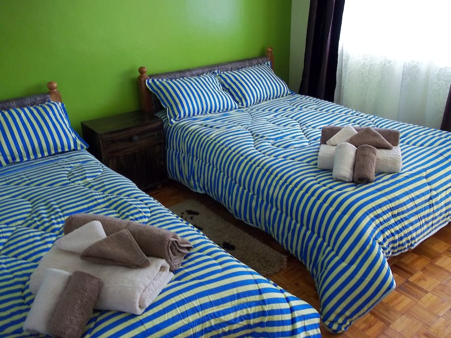 Twin beds suitable for two people sharing.