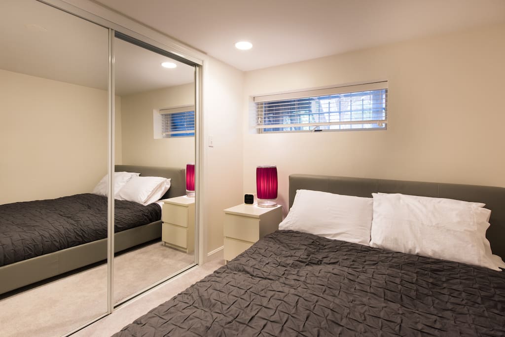 Cozy bedroom with queen platform bed and huge closet.