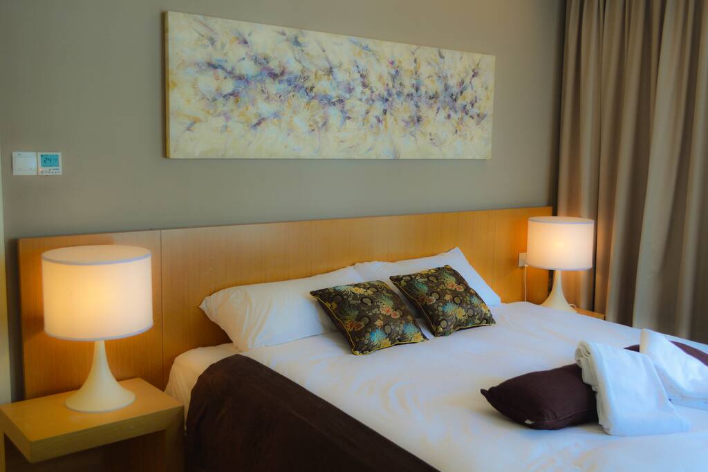 A king sized bed in a fully fitted room