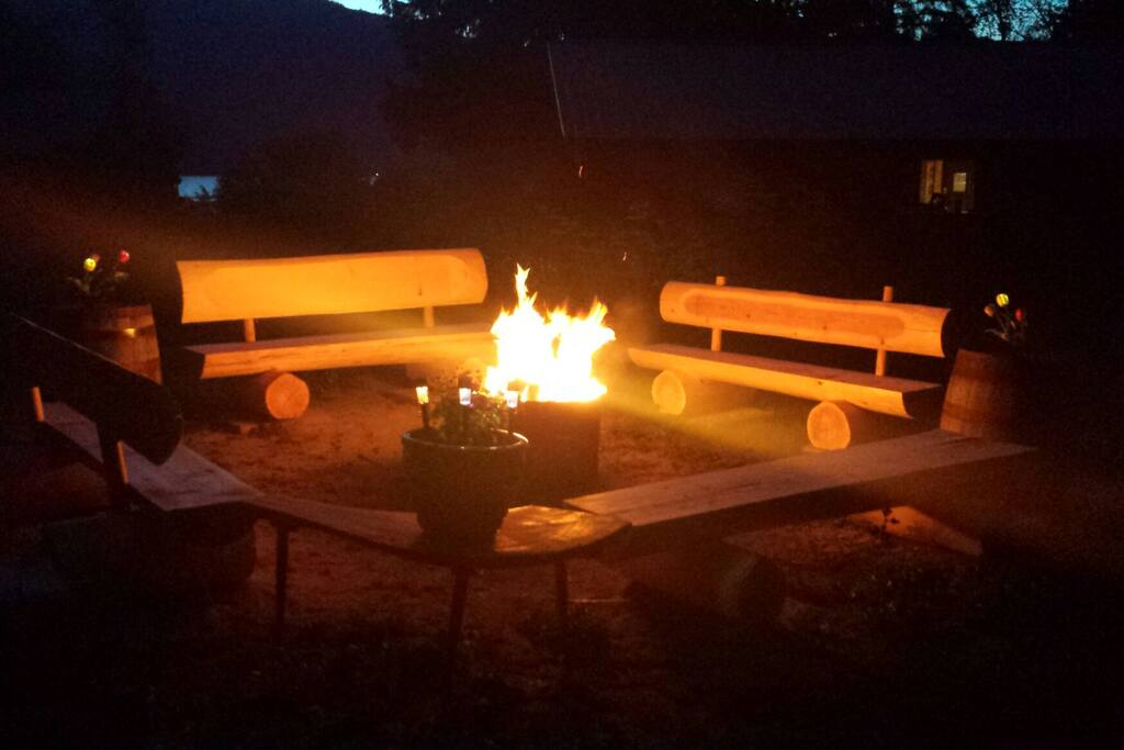Private Fire Pit with 4 Custom Log Benches and Solar Lighting. This fire pit #2 is located in the back yard.