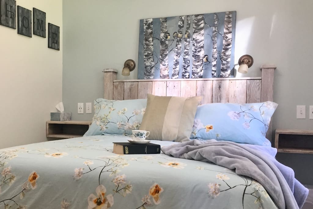 Super comfortable queen bed with bespoke reclaimed cedar headboard and night tables, built in reading lights with handy usb plugs make the bedroom a relaxing oasis.