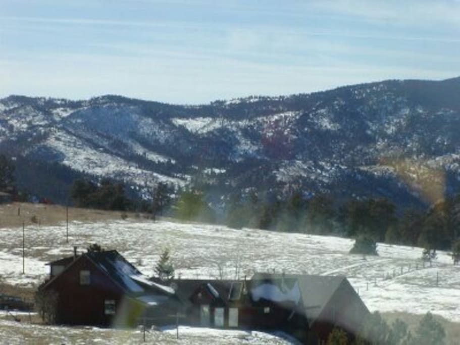Drake home back view winter with mountain vistas