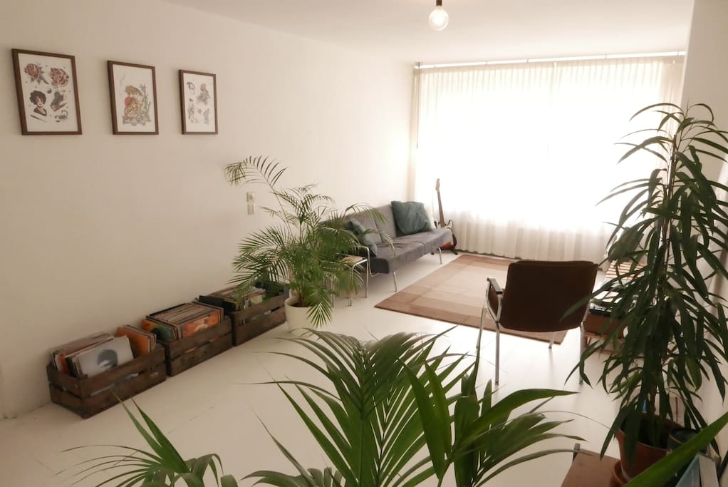 Spacious minimal living room with custom made prints by tattoo artist Lizer.
