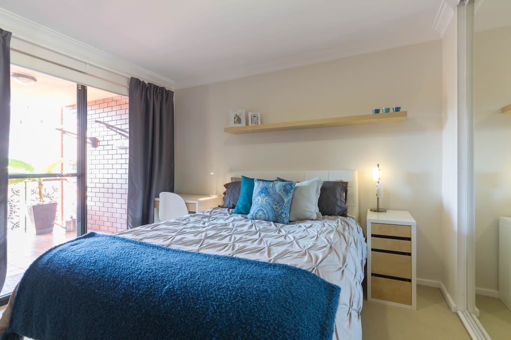 Queen size bed, room has dual rear balcony access (morning sun), full size inbuilt wardrobe, pedestal fan and work station