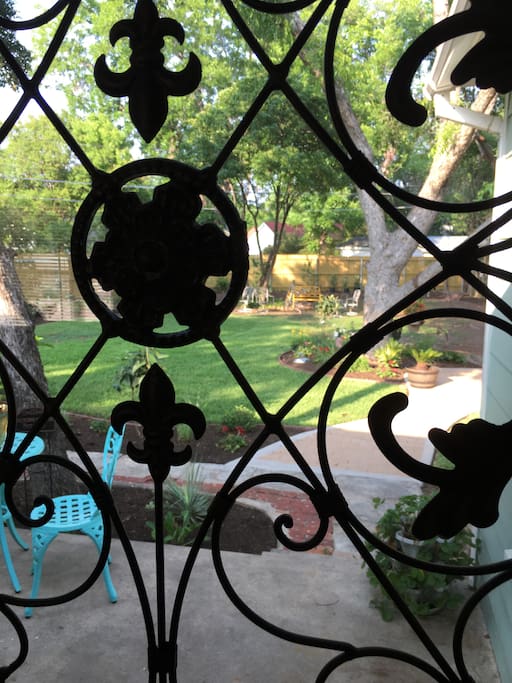 Lovely iron touch gives a glimpse of the backyard oasis