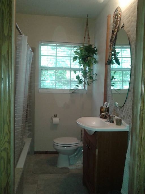 Tropical style bathroom with shower/tub combination.