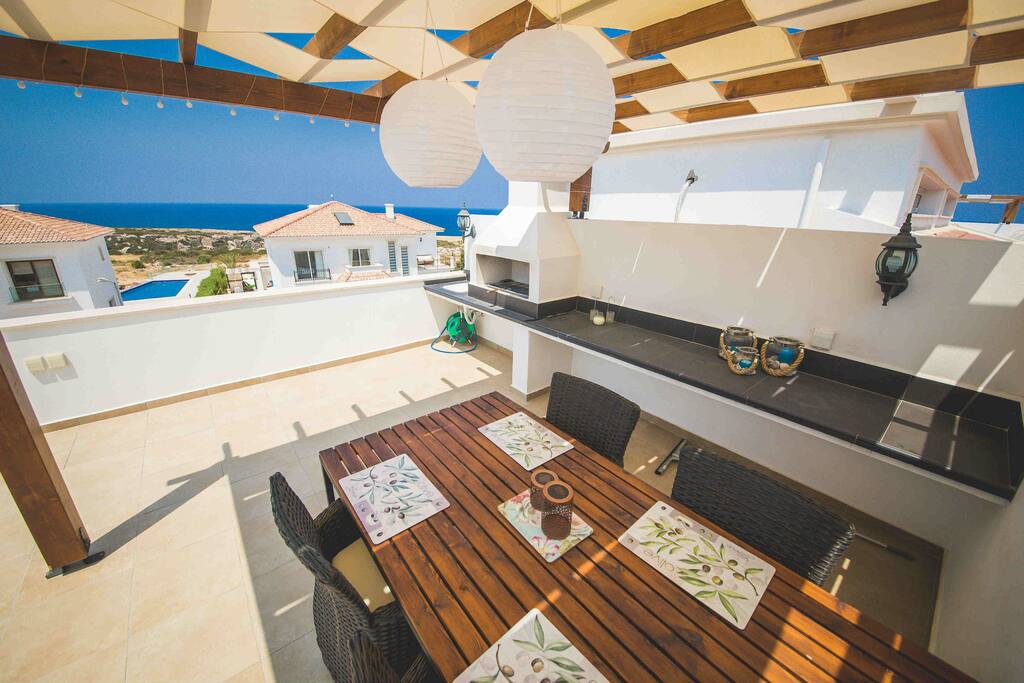 Large table with cooking facilities, a barbeque, sink and both warm and cold water.