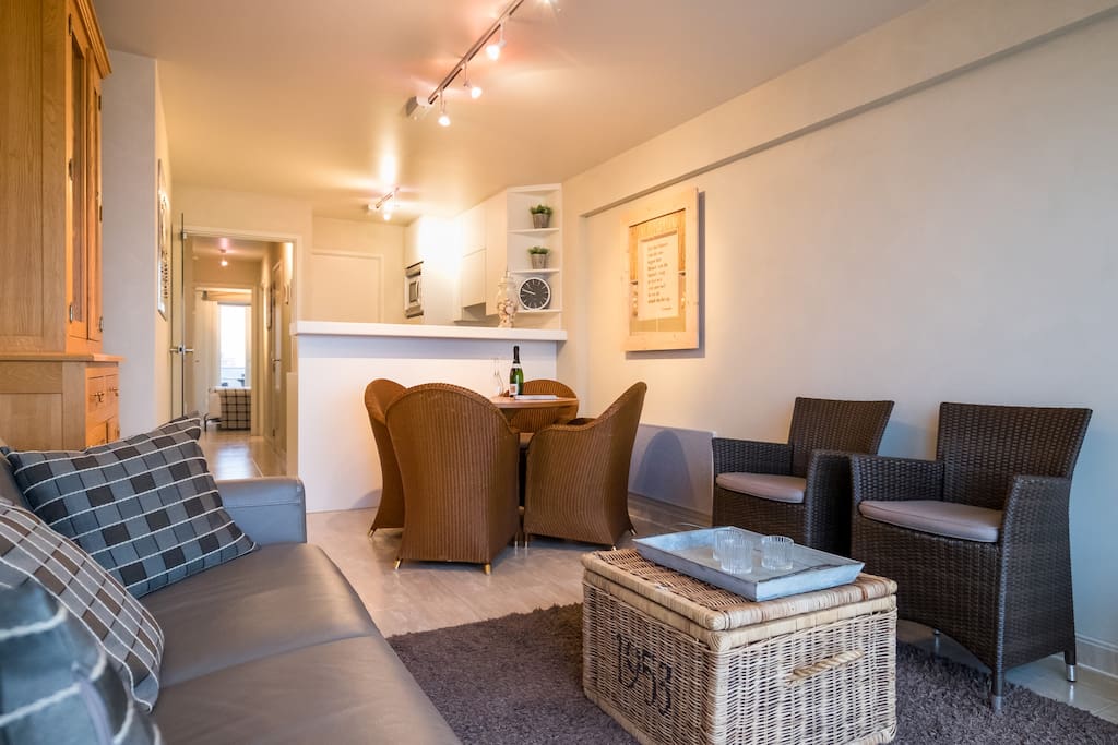 Sofas, dining table and view on the open kitchen
