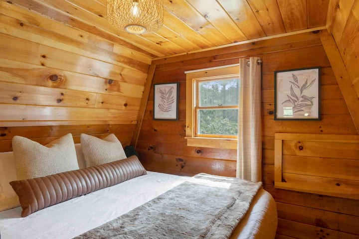 Our third bedroom offers a queen bed for cozy accommodations for your stay. This bedroom is an open loft area off of the main staircase.