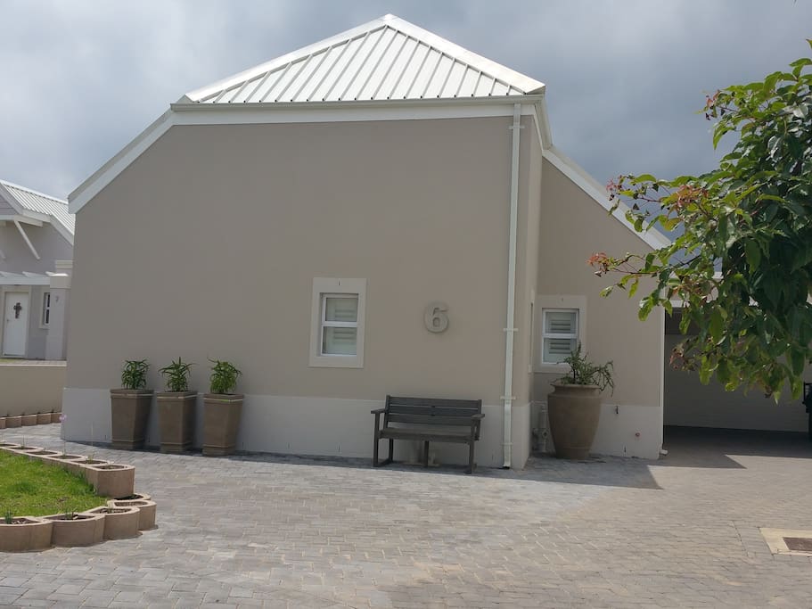 Front of house with parking in front and underneath carport. Double garage available.