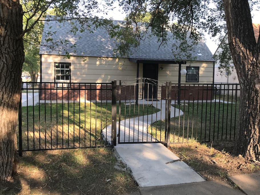 Front entrance with fence for a private atmosphere. you can park on Topeka st. and go thru the gate if you want, or you can park in our Aibnb private parking behind the house