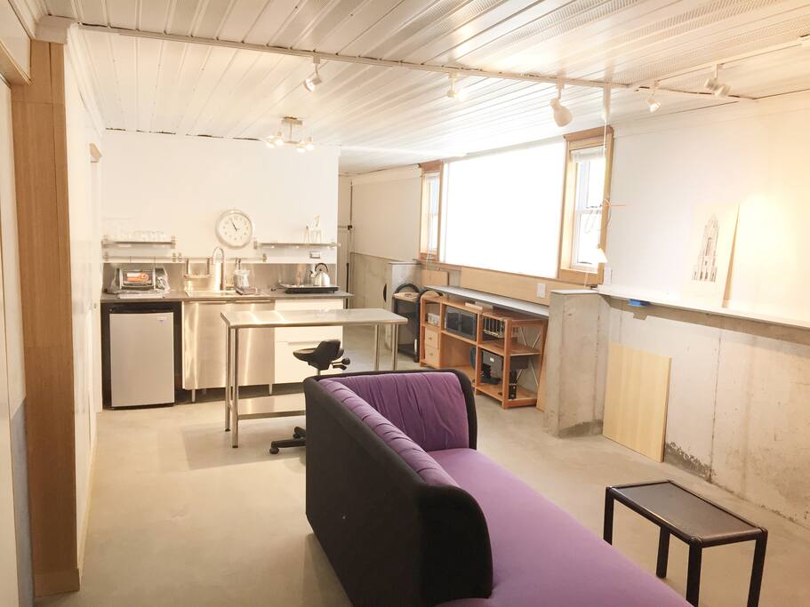 The bright daylit living/dining/ kitchen area.