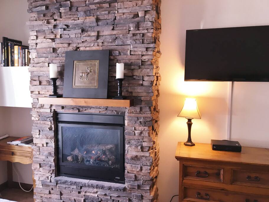 Warm, romantic gas fireplace and flat screen HDTV are at the foot of bed