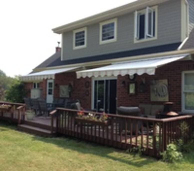 Back deck with babecue, outdoor speakers and a table that seats 8.