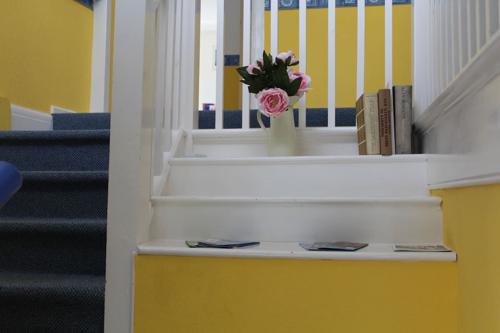 Private entrance with bright open stairs.