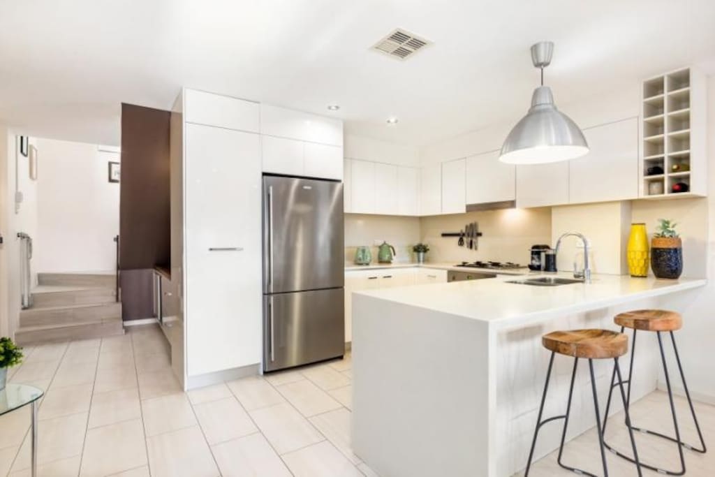 Shared kitchen - stairs take you up to your private Studio with Bed, Bathroom, desk and view