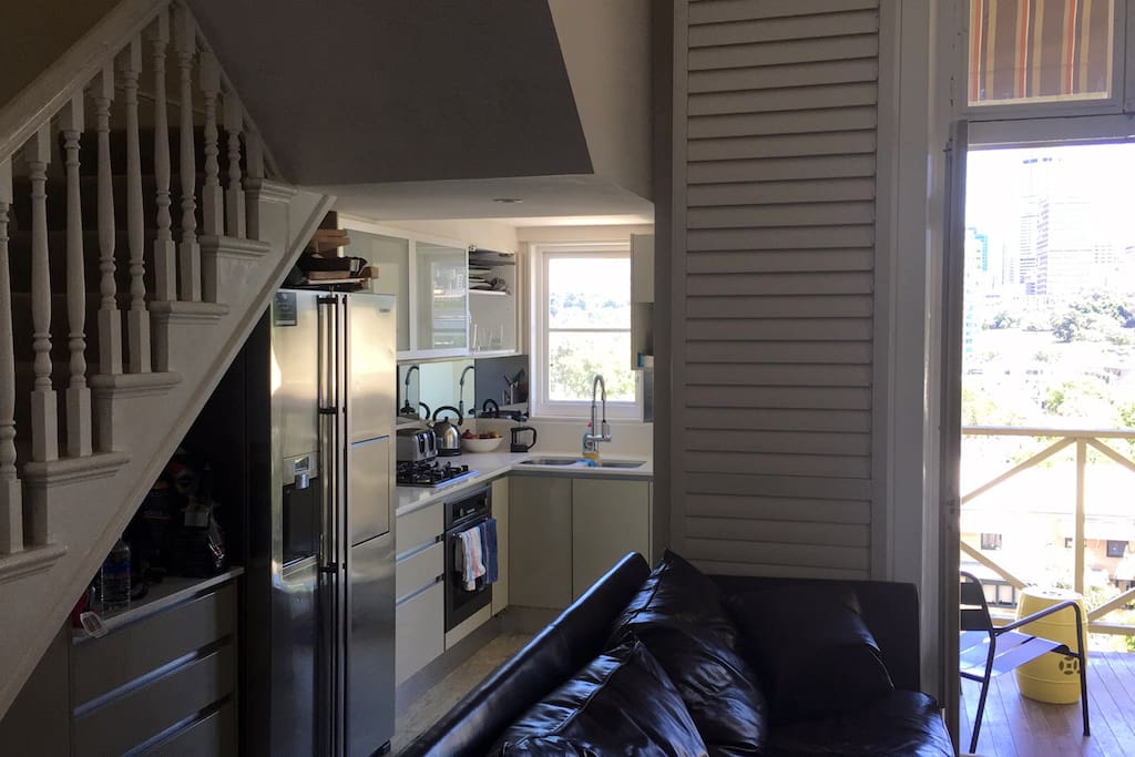 Living room and Kitchen leading on to balcony with city views