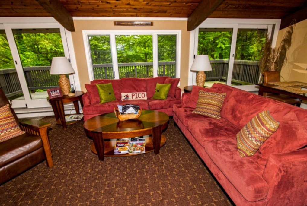 Large, cozy living room with wood burning stove.