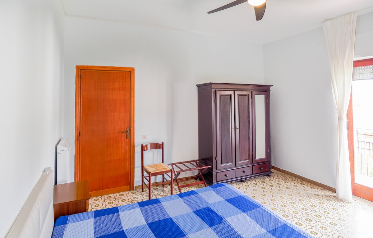 Master bedroom with a private balcony and a king-sized bed.