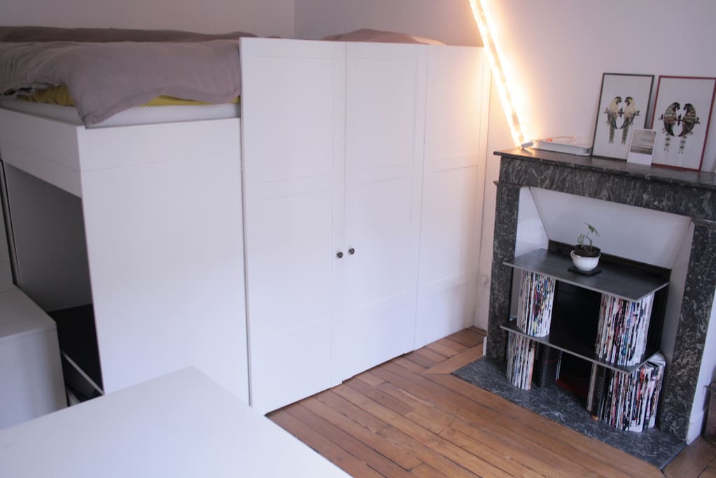 Bedroom includes a mezzanine bed with closet space at the foot of the bed.