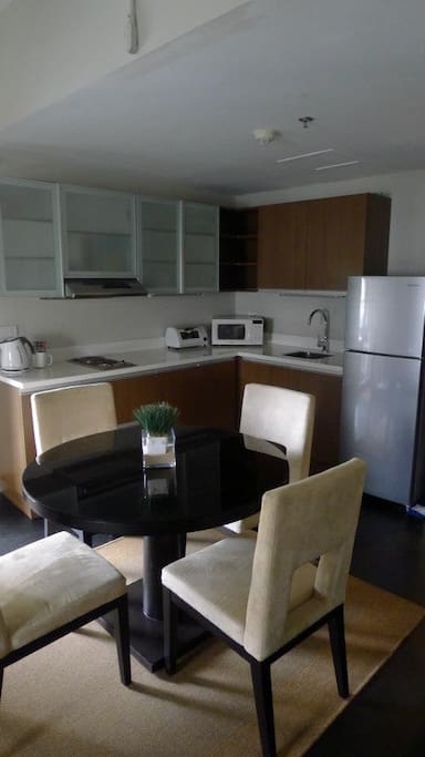 Kitchenette with 2 burner stovetop, full-sized refrigerator, microwave oven, toaster, hot water pot, hot water. Rice cooker and coffee maker and blender also available in cabinet below.