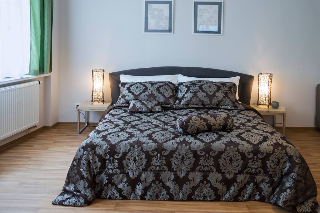 Living room with king-size bed for two person, foldout sofa for two person and recline chair for one person.