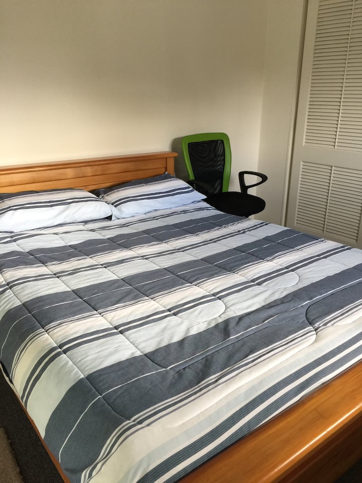 سرير بحجم كوين في غرفة نوم كبيرة