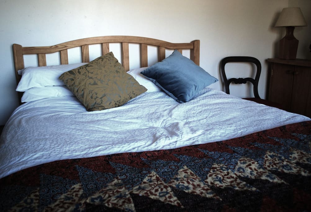 The king size double bed in the map room looks out over the quiet communal garden.