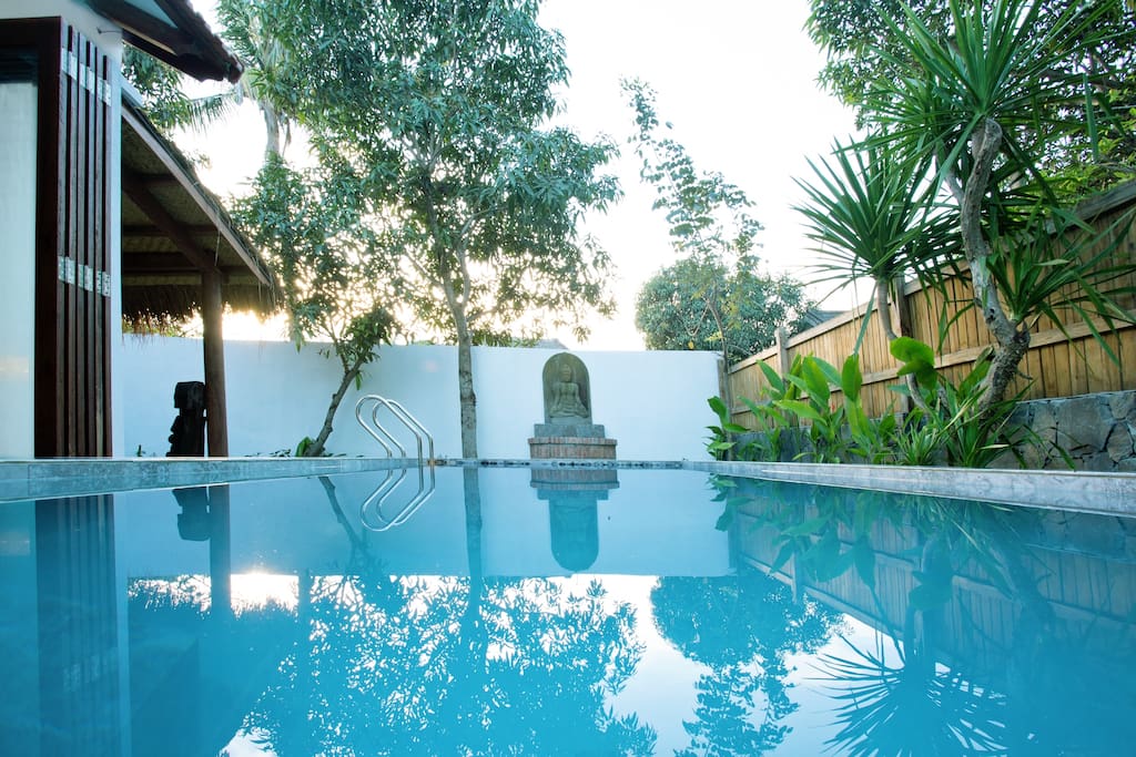 Swimming pool with traditional well and Buddha