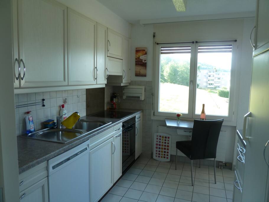 kitchen with oven, dishwasher, microwave, nespresso coffeemachine etc....and exit to the balcony west with nice view to the black forest or headquarter of underwear company Triumph