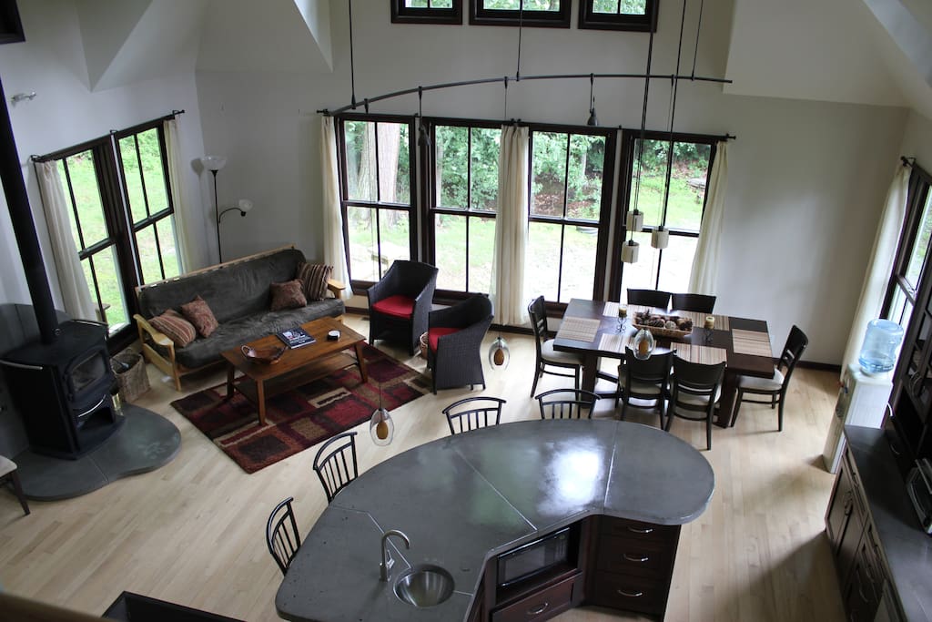 The greatest room, located within the kitchen and dining room. This sitting room is equipped with a wood stove, wall to wall windows and doors for a panoramic view of the great outdoors. the true cathedral ceiling increases the expansiveness of this space, leaving you feeling like you are in a looking glass.