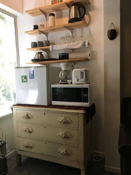 Kitchen includes mini-fridge, microwave, toaster, coffee maker, and electric kettle, dishes and essential utensils.