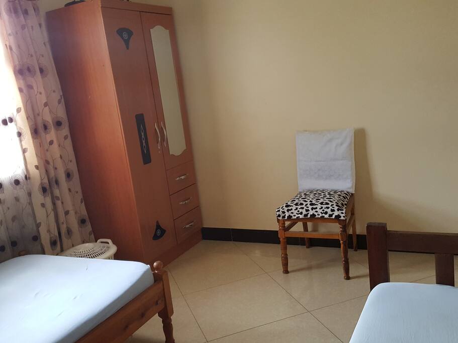 View in second room showing cabinet, laundry basket, workout chair