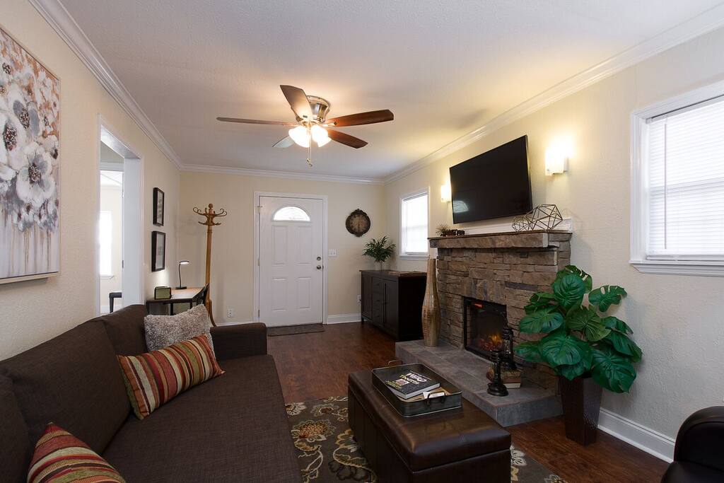 The large couch in the living room opens to a queen sized sleeping space.