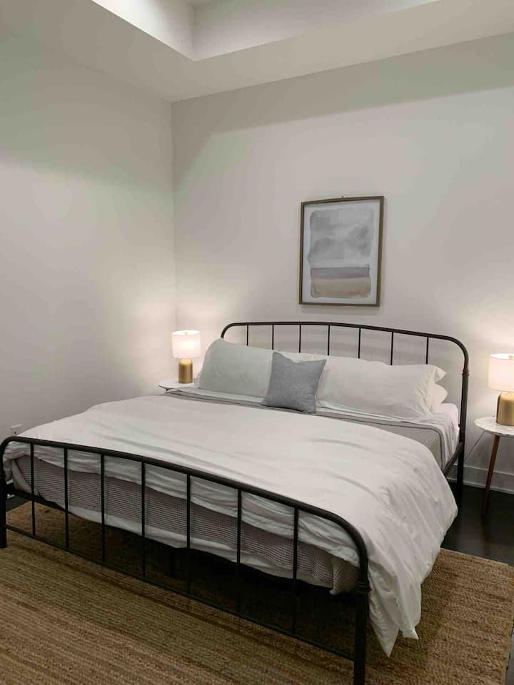 This "Den" room has a king sized bed w/ luxury sheets and a fluffy down comforter. We even included satin pillow cases, a 50" smart tv and an attached full bathroom.  Note: not a legal bedroom-no window. Commercial sprinklers throughout the building.